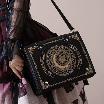Gothic spellbook crossbody bag in black faux leather with celestial moon embossing and gold occult detailing from Alternative Darkwear