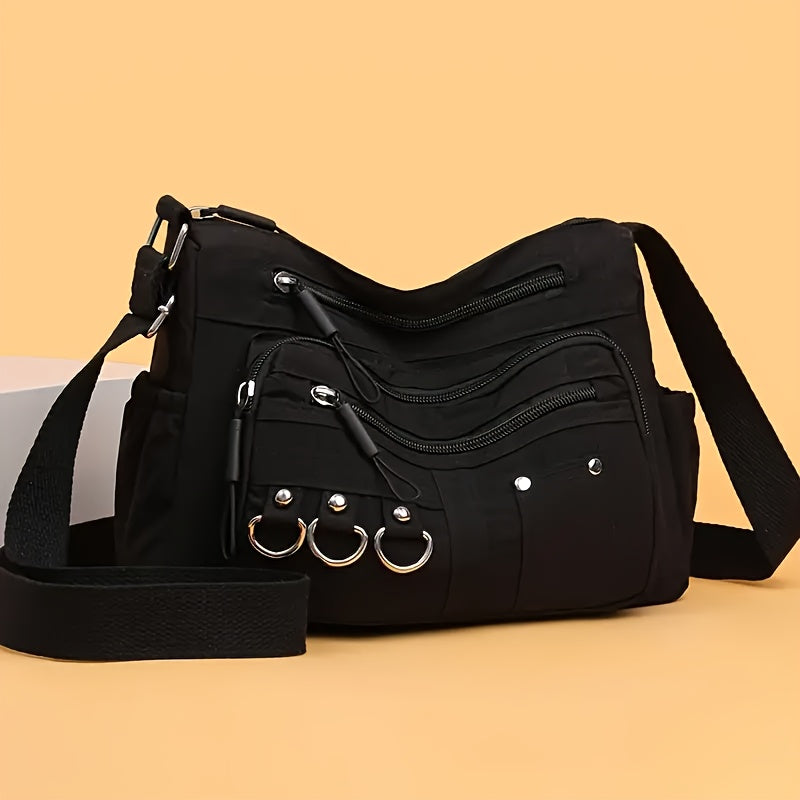 Multi-pocket hobo crossbody bag in black with D-ring hardware and adjustable strap from Alternative Darkwear