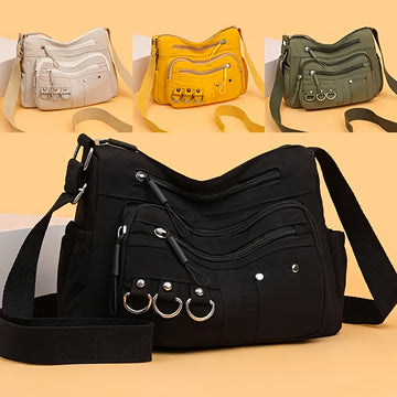 Multi-pocket hobo crossbody bag showing all four colorways — black, green, yellow and beige — from Alternative Darkwear